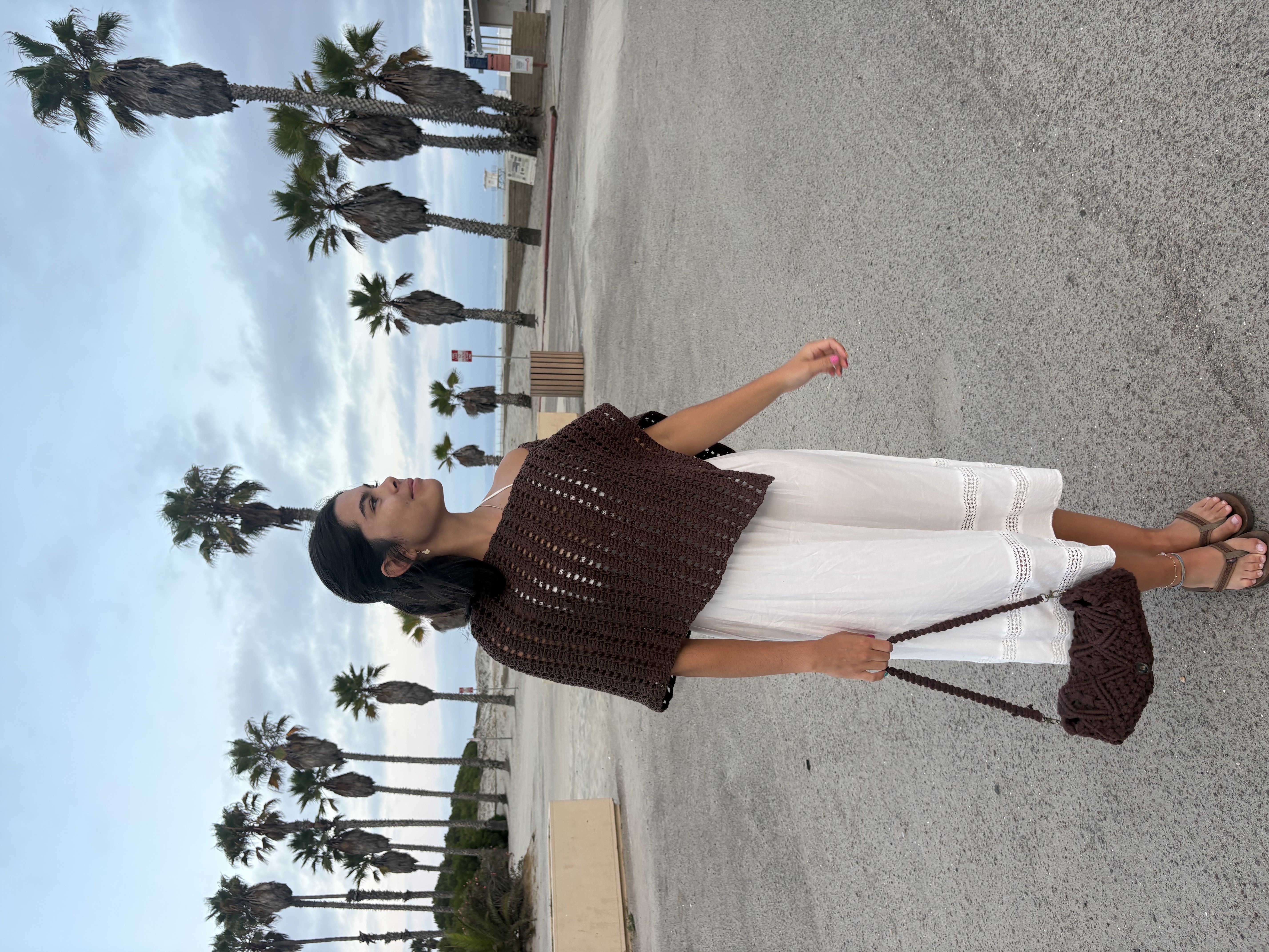 Nicole wearing a crochet top and bag she made