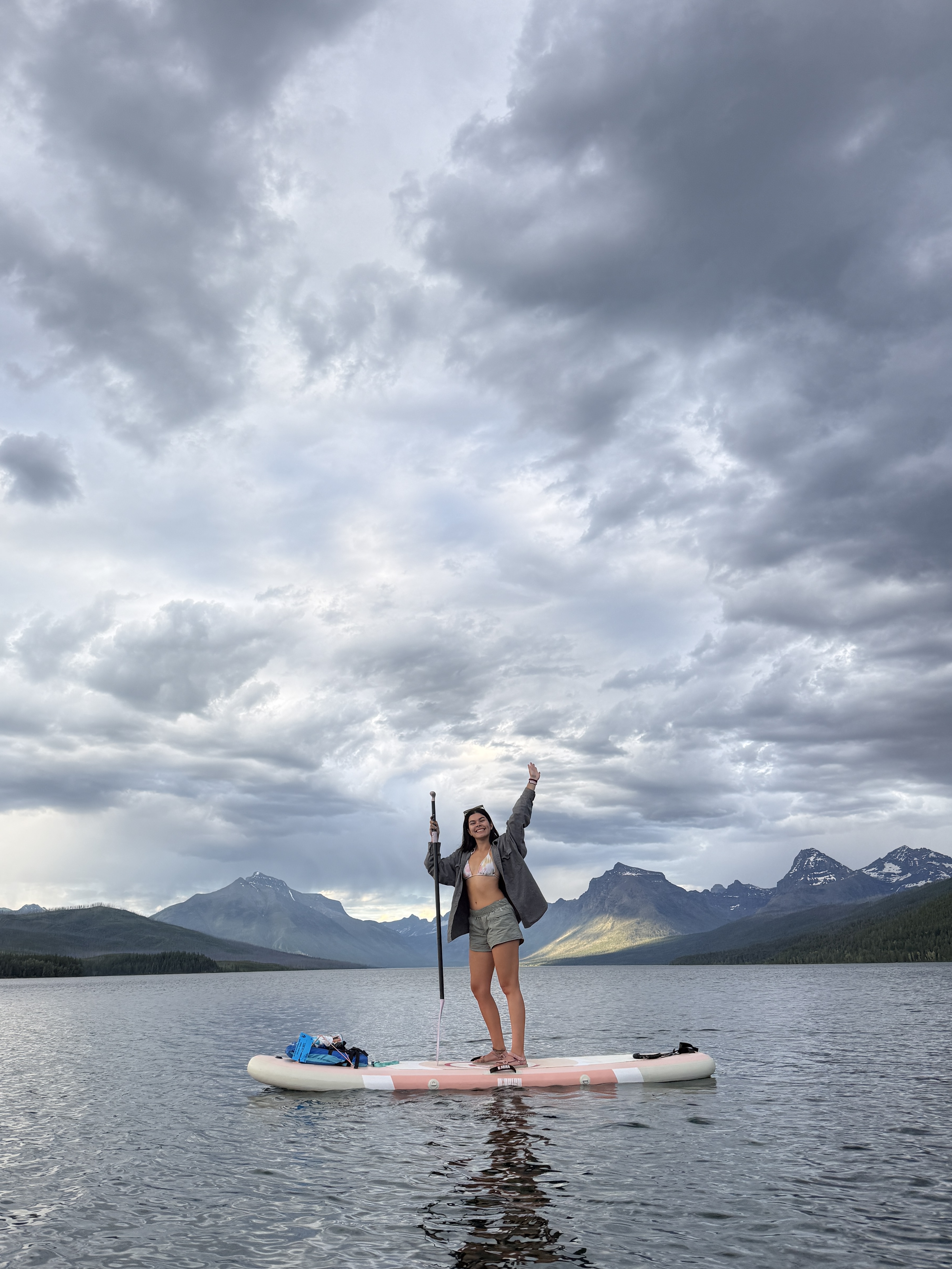 Nicole paddleboarding on a mountain lake