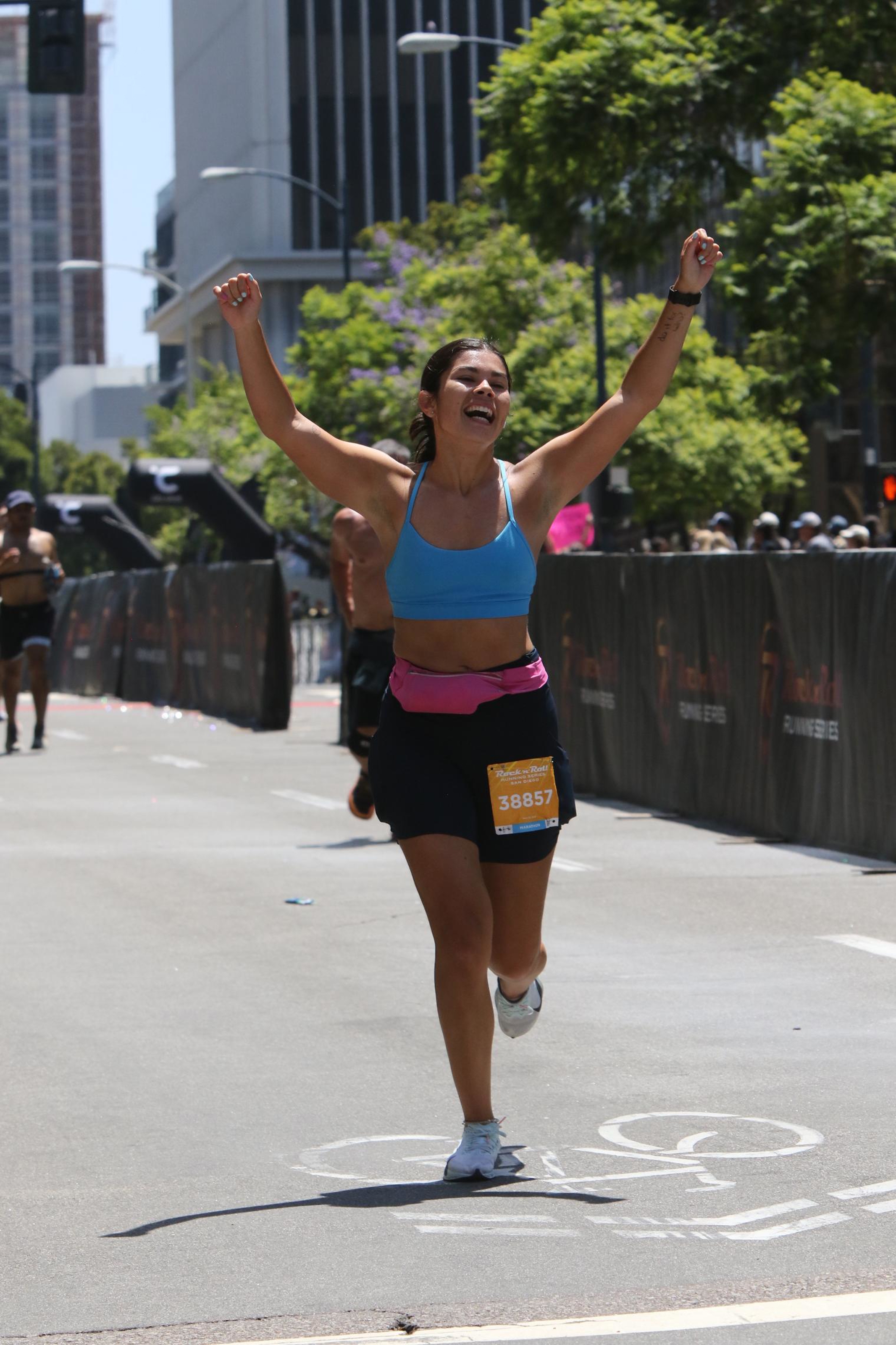 Nicole celebrating at the finish line of the Rock 'n' Roll San Diego Marathon